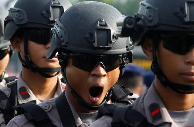 An anti-riot policeman yawns as he stands during security preparations ahead of Friday's planned protest by hardline Muslim groups in Jakarta, Indonesia, November 2, 2016. (Photo by Iqro Rinaldi/Reuters)