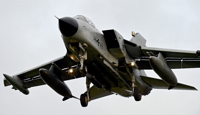 Tornado combat aircraft of the German air force's reconnaissance squadron 51 prepare for touchdown at the air base in Jagel, Germany, 01 December 2015. The German government decided to deploy reconnaissance aircraft and up to 1200 German soldiers in the fight against the militant group Islamic State (IS). They will assist in the airstrikes against the IS, particulary in Syria and Iraq. (Photo by Carsten Rehder/EPA)