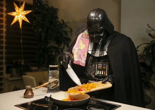 Darth Mykolaiovych Vader, who is dressed as the 'Star Wars' character Darth Vader, poses for a picture as he cooks in the kitchen of his apartments in Odessa, Ukraine, December 2, 2015. (Photo by Valentyn Ogirenko/Reuters)