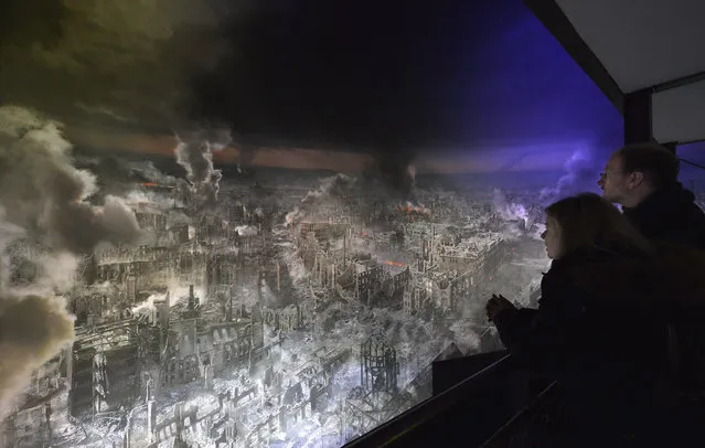 Visitors stand in front of a giant, 360 degree panorama display that depicts the city of Dresden in the aftermath of the Allied firebombing during the press preview on January 23, 2015 in Dresden, Germany. On February 13, 1945, only months before the end of World War II, British and U.S. bombers obliterated the historic city center, killing at least 25,000 people. (Photo by Matthias Rietschel/Getty Images)