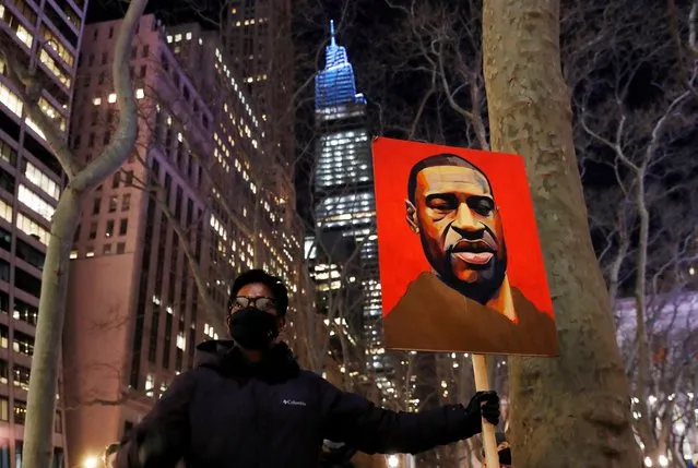 A demonstrator holds up an image of George Floyd during a rally on the first day of the trial of former Minneapolis police officer Derek Chauvin, on murder charges in the death of Floyd, in New York City, New York, U.S., March 8, 2021. (Photo by Shannon Stapleton/Reuters)