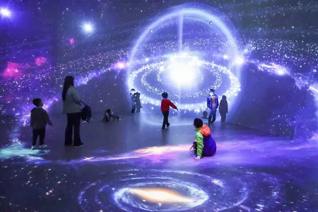 Children enjoy the installation in the cosmic dust theatre, part of the manned space interactive science exhibition at the China Science and Technology Museum in Beijing, China on March 21, 2021. (Photo by Sipa Asia/Rex Features/Shutterstock)
