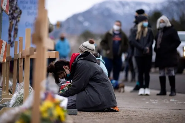 King Soopers employee Starr Samkus, 20, cries at the site of a mass shooting at King Soopers grocery store in Boulder, Colorado, March 23, 2021. Samkus was not working when the shooting occurred. (Photo by Alyson McClaran/Reuters)