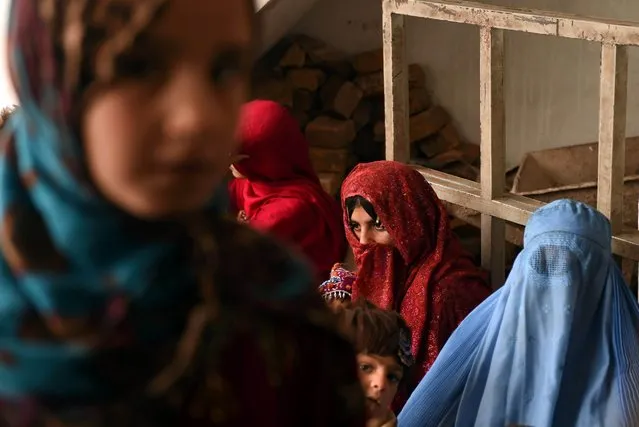 Afghan refugees woman gather for renewal of their family cards at the Chamkany registration centre on the outskirts of Peshawar on December 31, 2015. Hundreds of thousands of people fled Afghanistan during the last three decades of war, with a majority of them taking refuge in neighbouring Pakistan. (Photo by A. Majeed/AFP Photo)