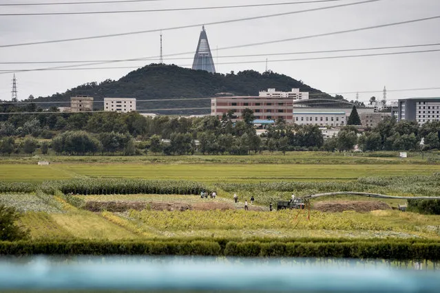 The Ryugyong Hotel is visible on the horizon from a window of the motorcade carrying Secretary of State Mike Pompeo as it makes its way to the Park Hwa Guest House in Pyongyang, North Korea, Friday, July 6, 2018. (Photo by Andrew Harnik/AP Photo)