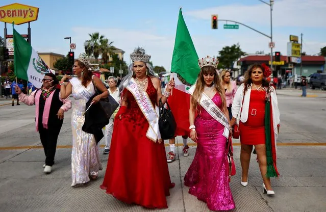 Participants representing Jalisco state walk toward their float before riding in the 77th annual East LA Mexican Independence Day Parade on September 10, 2023 in Los Angeles, California. The parade is the largest and longest-running Mexican heritage parade in the U.S which has celebrated Mexican culture and history in the East LA community since 1946. (Photo by Mario Tama/Getty Images)