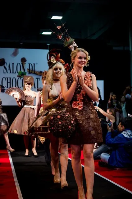 London, United Kingdom. 18th October 2013. Models showcases a chocolate dress at the London Chocolat Fashion show 2013.  Salon du Chocolat, the world's largest chocolate show comes to London. This spectacular finish to a wonderful line up of Chocolate Week activities takes place from 18th-20th October at National Hall, Olympia. (Photo by Anastasia Mishchenko/Demotix Photojournalist)