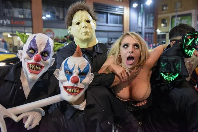 Ghoulish Brits took the streets on on Saturday, October 27, 2018 with fake blood as they celebrated Halloween a few days early. These scary clowns and partygoers took to the streets of Birmingham to celebrate Halloween early. (Photo by Caters News Agency)