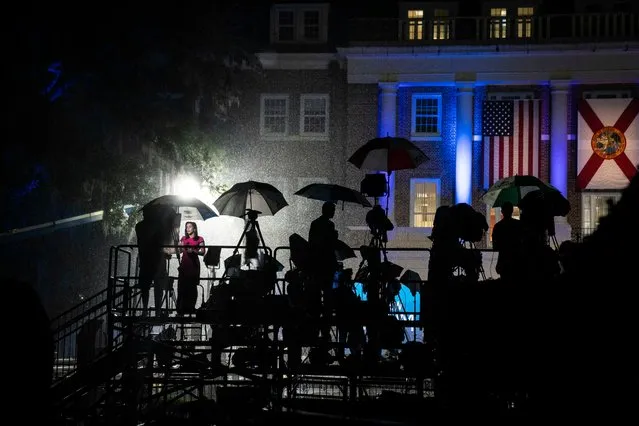 Reporters go on the air in the rain as Florida Democratic gubernatorial candidate Andrew Gillum speaks at an election night watch party in front of Lee Hall at Florida A&M University (FAMU) in Tallahassee on November 6, 2018. (Photo by Jabin Botsford/The Washington Post)