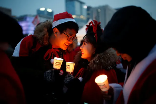 People dressed in Santa's costumes attend a protest demanding South Korean President Park Geun-hye's resignation in Seoul, South Korea, December 24, 2016. (Photo by Kim Hong-Ji/Reuters)