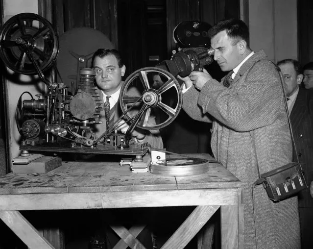 On March, 22, 1895, French pioneer Louis Lumiere presented his first motion picture. Paris is now celebrating the 60th anniversary of movie-making. Camera operator Pierre ERE checks the projector on March 23, 1955, used by Louis Lumiere 60 years ago. At center, an unidentified cameraman. (Photo by H. Babout/AP Photo)