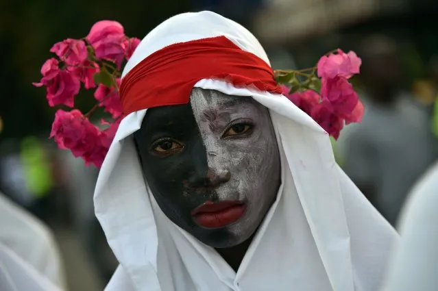 A reveler performs during of 2016 National Carnival Parade on February 9, 2016, in Port-au-Prince, Haiti. The name of the carnival for this year is Ayiti Toutan, in Haitian creole,(Haiti always). Yesterday was suspended the first day of carnival by the political situation affecting Haiti. The name in Haitian creole of the carnival for this year is  “Ayiti Toutan” (Haiti Always). The launch of the carnival the previous day was suspended tdue to the political situation affecting Haiti. (Photo by Hector Retamal/AFP Photo)