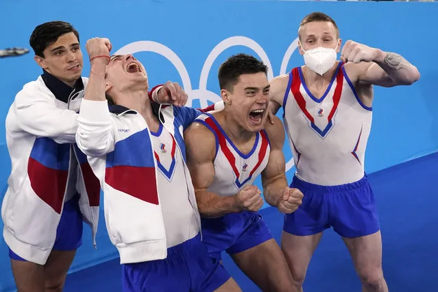 Russian Olympic Committee's artistic gymnastics men's team, from right, Denis Abliazin, Nikita Nagornyy, David Belyavskiy and Artur Dalaloyan celebrate after winning the gold medal at the 2020 Summer Olympics, Monday, July 26, 2021, in Tokyo. (Photo by Gregory Bull/AP Photo)