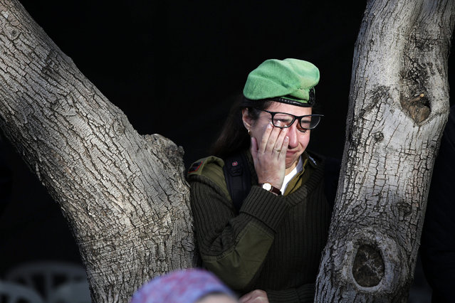 An Israeli solider mourns at the grave of Israeli Army lieutenant Yael Yekutiel during his funeral at the Kiryat Shaul Military Cemetery in Tel Aviv, Israel, 09 January 2017. Yekutiel  was one of the four Israeli soldiers in a truck attack in Jerusalem on 08 January during which also 15 others were wounded. The driver of the truck, reported by local media to be an Arab Israeli from East Jerusalem, was shot and killed by security forces at the scene. (Photo by Abir Sultan/EPA)