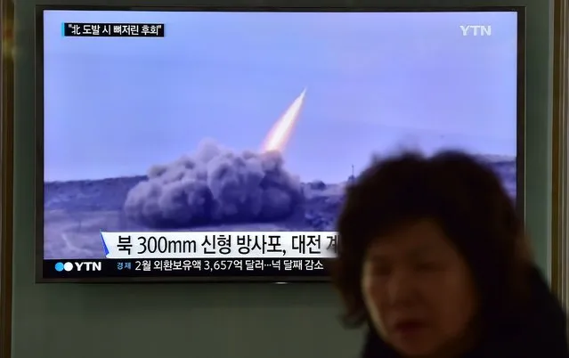 A woman walks past a public television screen showing file footage of a North Korean missile, at a railway station in Seoul on March 4, 2016. North Korean leader Kim Jong-Un has ordered its nuclear arsenal readied for pre-emptive use at anytime, in an expected ramping up of rhetoric following the UN Security Council's adoption of tough new sanctions on Pyongyang. (Photo by Jung Yeon-Je/AFP Photo)