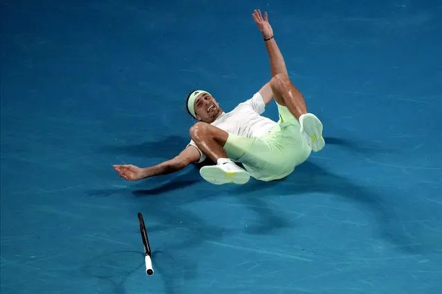 Alexander Zverev of Germany falls during his quarterfinal match against Carlos Alcaraz of Spain at the Australian Open tennis championships at Melbourne Park, Melbourne, Australia, early Thursday, January 25, 2024. (Photo by Louise Delmotte/AP Photo)