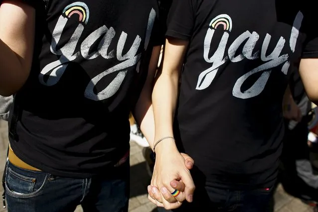 A gay couple hold hands during the Tokyo Rainbow Pride parade in Tokyo April 26, 2015. (Photo by Thomas Peter/Reuters)