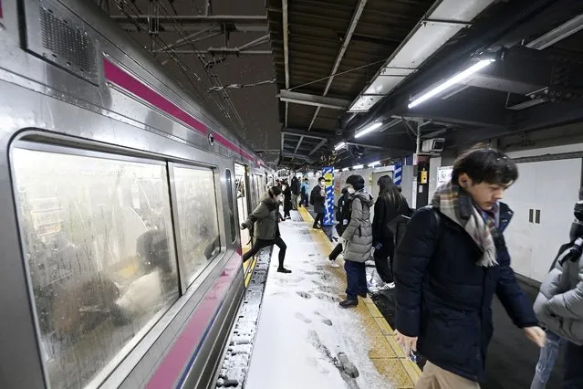 Passengers are seen on a snow covered train platform during the first snowfall of the year in Tokyo, Japan on February 05, 2024. (Photo by David Mareuil/Anadolu via Getty Images)