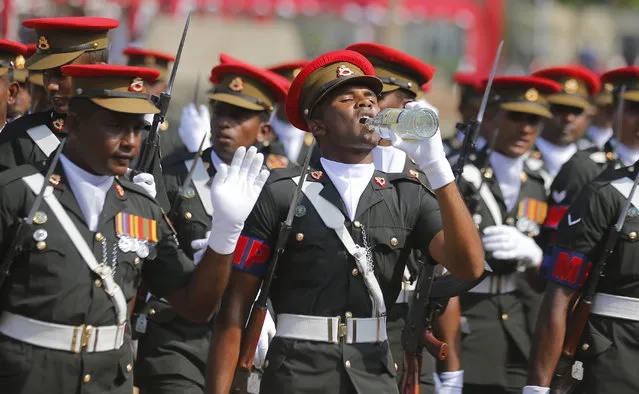 Sri Lankan military police soldiers march as one among them drinks water as they rehearse for the Independence Day parade in Colombo, Sri Lanka, Thursday, February 2, 2017. Sri Lanka will commemorate the 69th anniversary of gaining independence from British colonial rulers on February 4. (Photo by Eranga Jayawardena/AP Photo)