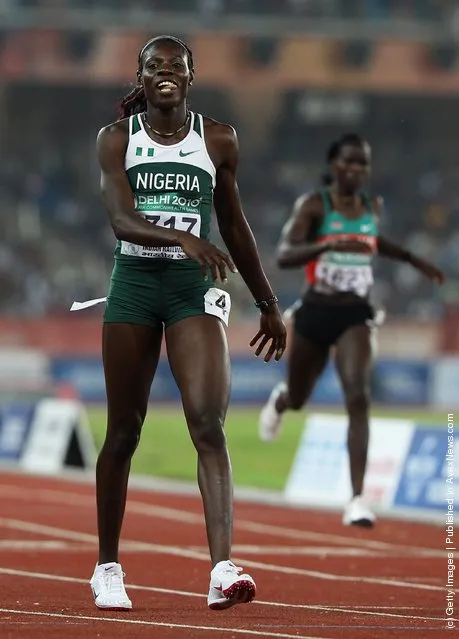 Muizat Odumosu of Nigeria smiles after winning the women's 400 metres hurdles final at Jawaharlal Nehru Stadium during day seven of the Delhi 2010 Commonwealth Games on October 10, 2010 in Delhi, India