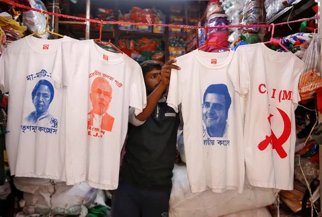 A worker displays T-shirts with images of (L-R) Chief Minister of West Bengal state Mamata Banerjee, Prime Minister Narendra Modi, Congress party chief Rahul Gandhi and logo of Communist Party of India (Marxist) CPI (M), for sale inside a shop at a market ahead of the general election, in Kolkata, March 26, 2019. (Photo by Rupak De Chowdhuri/Reuters)