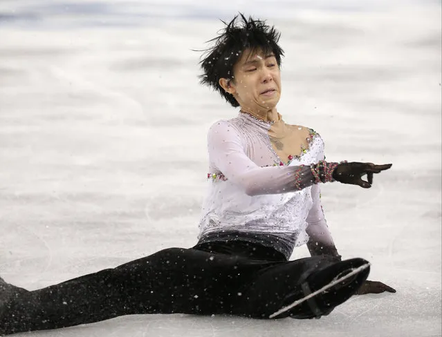 Yuzuru Hanyu of Japan falls as he competes in the men's free skate figure skating final at the Iceberg Skating Palace during the 2014 Winter Olympics, Friday, February 14, 2014, in Sochi, Russia. (Photo by Bernat Armangue/AP Photo)