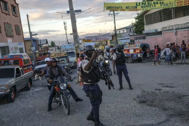 Police officers patrol at an intersection in Port-au-Prince, Haiti, Thursday, November 11, 2021. (Photo by Matias Delacroix/AP Photo)