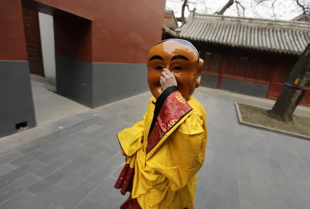 A Tibetan monk adjusts his mask as he arrives for a religious ceremony, known as “Da Gui” or beating ghost, to celebrate the upcoming Tibetan New Year which starts on March 1 at Yonghegong Lama Temple, in Beijing, on February 28, 2014. (Photo by Jason Lee/Reuters)