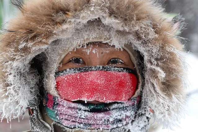 A man in Yakutsk, the capital of the Sakha Republic (Yakutia) in the Russian Far East on November 23, 2021. Located in Tuimaada Valley on the Lena River, Yakutsk is the largest city in the permafrost zone. On 23 November 2021, the daytime temperature ranged between –35 and –31 degrees Celsius in Yakutsk. On the night between 22 and 23 November, the temperature went down to –37 degrees Celsius. (Photo by Vadim Skryabin/TASS)