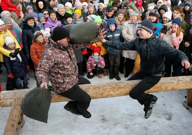 Men take part in a pillow fight contest during celebration of Maslenitsa, or Pancake Week, a pagan holiday marking the end of winter, at the Bobrovy Log ski resort in the suburbs of the Siberian city of Krasnoyarsk, Russia, February 26, 2017. (Photo by Ilya Naymushin/Reuters)