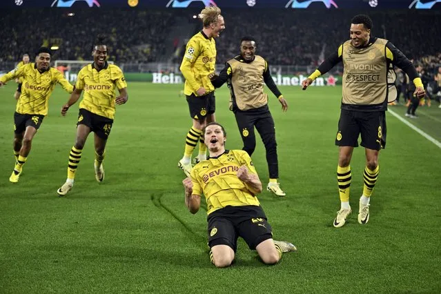Dortmund's Marcel Sabitzer, center, celebrates his side's fourth goal during the Champions League quarterfinal second leg soccer match between Borussia Dortmund and Atletico Madrid at the Signal-Iduna Park in Dortmund, Germany, Tuesday, April 16, 2024. (Photo by Bernd Thissen/dpa via AP Photo)