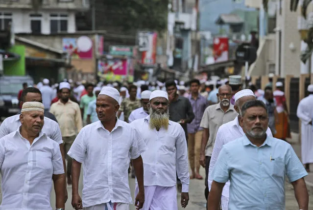 Sri Lankan Muslims leave after offering Friday prayers in Colombo, Sri Lanka, Friday, April 26, 2019. Across Colombo, there was a visible increase of security as authorities warned of another attack and pursued suspects that could have access to explosives. Authorities had told Muslims to pray at home rather than attend communal Friday prayers that are the most important religious service for the faithful. At one mosque in Colombo where prayers were still held, police armed with Kalashnikov assault rifles stood guard outside. (Photo by Manish Swarup/AP Photo)