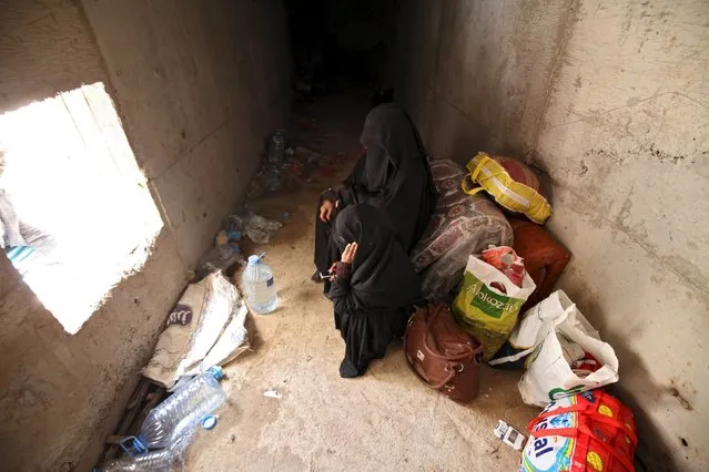 Women rest in an underground water tunnel with other displaced people (not pictured) after they were forced to flee their home due to ongoing air-strikes carried out by the Saudi-led coalition in Sanaa May 2, 2015. (Photo by Mohamed al-Sayaghi/Reuters)