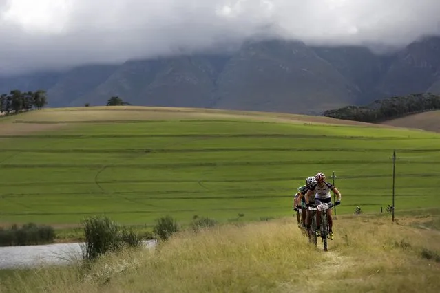 Riders compete in stage 4 of the annual ABSA Cape Epic mountain bike stage race, Greyton, South Africa, 27 March 2014. (Photo by Kim Ludbrook/EPA)