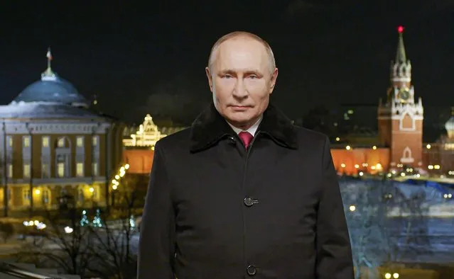 In this photo released by Kremlin Press service on Saturday, January 1, 2022, Russian President Vladimir Putin speaks during a recording of his annual televised New Year's message on New Year's eve in the Kremlin in Moscow, Russia. Russian President Vladimir Putin on Friday wished Russians positive changes in the new year, hailing their solidarity and strength in the face of tough challenges like the coronavirus pandemic. President Vladimir Putin is wishing Russians a happier new year, hailing their solidarity and strength in the face of tough challenges like the coronavirus pandemic. In a televised address broadcast just before midnight in each of Russia's 11 time zones, Putin said the nation has faced "colossal challenges but has learned to live in those harsh conditions and solve difficult tasks thanks to our solidarity." Putin's address to the nation on Friday was broadcast hours after his phone call with U.S. President Joe Biden, which focused on next month's talks to discuss Moscow's demand for Western security guarantees amid a Russian troop buildup near Ukraine.(Photo by Kremlin Pool Photo via AP Photo)