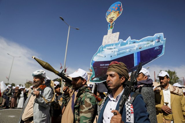 Houthi followers hold a cutout banner, portraying the Galaxy Leader cargo ship which was seized by Houthis, during a parade as part of a 'popular army' mobilization campaign by the movement, in Sanaa, Yemen on February 7, 2024. (Photo by Khaled Abdullah/Reuters)