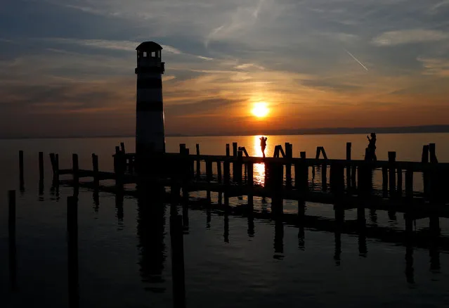 Tourists are seen during sunset at lake Neusiedl in Podersdorf, Austria on March 29, 2019. (Photo by Leonhard Foeger/Reuters)