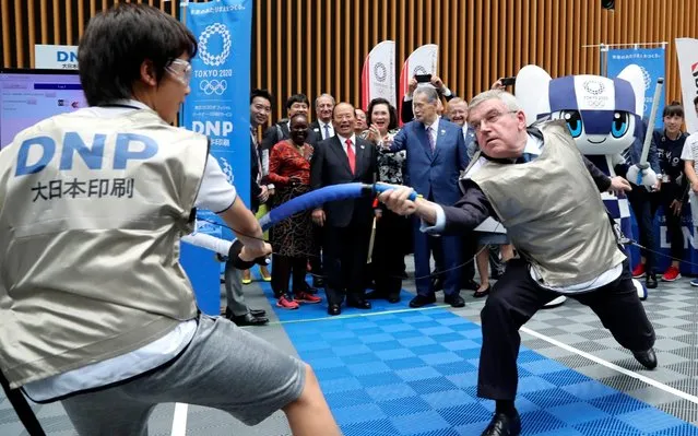 IOC President Thomas Bach, right, performs mock fencing with Japanese junior high school student Yui Hashimoto during a Olympic Games Tokyo 2020 One year to Go ceremony event in Tokyo, Wednesday, July 24, 2019. Bach is a former Olympic fencer and won a team gold medal at the 1976 Montreal Games. Fans, sponsors and politicians celebrated the day around the Japanese capital, displaying placards and clocks showing 365 days to go until the opening ceremony on July 24, 2020. (Photo by Koji Sasahara/AP Photo/Pool)