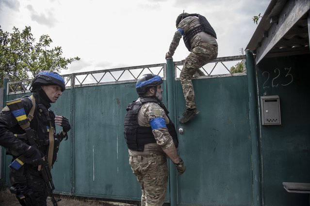 Police officers inspect a neighborhood for evacuation of civilians on a village nearby Vovchansk City as Russian military offensive advances on north of Kharkiv region, Kharkiv Oblast, Ukraine, May 19, 2024. (Photo by Narciso Contreras/Anadolu via Getty Images)