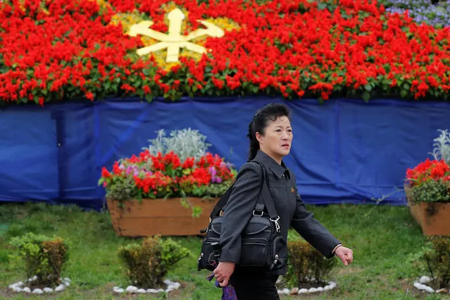 A woman passes decoration placed near April 25 House of Culture, the venue of the Workers' Party of Korea (WPK) congress in Pyongyang, North Korea May 6, 2016. (Photo by Damir Sagolj/Reuters)
