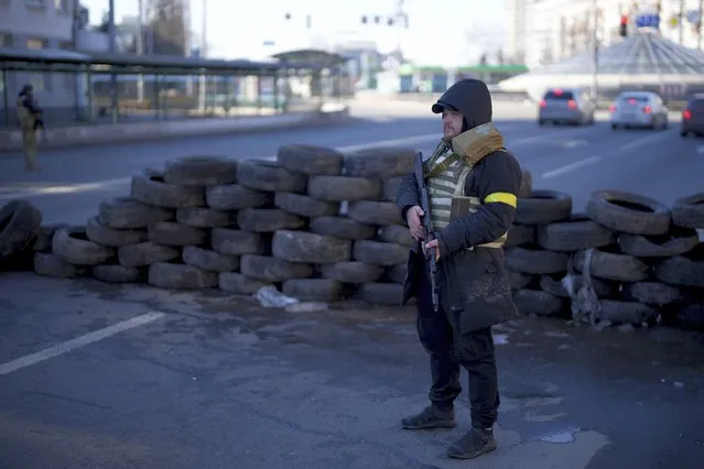 Civil defense personnel man a checkpoint in Kyiv, Ukraine, Saturday, February 26, 2022. (Photo by Emilio Morenatti/AP Photo)