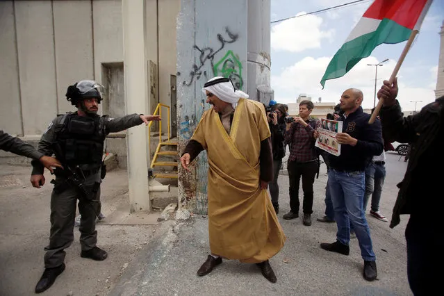 A Palestinian demonstrator argues with an Israeli border policeman during a protest in the West Bank city of Bethlehem April 14, 2017. (Photo by Mussa Qawasma/Reuters)