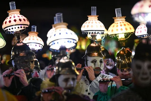 Revellers parade with lanterns during the traditional “Morgenstreich” procession starting the carnival of Basel on March 7, 2022. (Photo by Sebastien Bozon/AFP Photo)