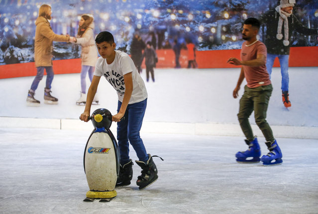 Iraqis skate at the Zayouna Mall ice skating rink in the capital Baghdad on June 16, 2024. (Photo by Ahmad Al-Rubaye/AFP Photo)
