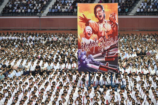 Participants attend a rally at the Mayday Stadium in Pyongyang on June 25, 2024, to mark the “Day of Struggle Against US imperialism”, on the 74th anniversary of the three-year Korean War, which began on June 25, 1950. (Photo by Kim Won Jin/AFP Photo)