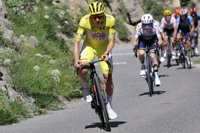 UAE Team Emirates team's Slovenian rider Tadej Pogacar wearing the overall leader's yellow jersey cycles ahead of Team Visma - Lease a Bike team's Danish rider Jonas Vingegaard in the ascent of Col du Noyer during the 17th stage of the 111th edition of the Tour de France cycling race, 177,8 km between Saint-Paul-Trois-Chateaux and Superdevoluy, in the French Alps, on July 17, 2024. (Photo by Thomas Samson/AFP Photo)