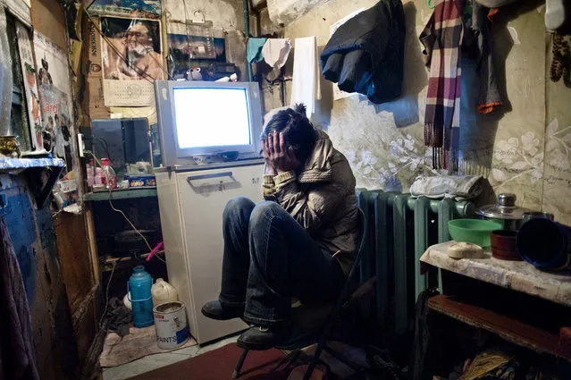 Asia, Mongolia, Ulaan Baator, March 22, 2011. Dyun Erdene, 26-year-old, former shepherd, sits in the tight space she shares with her family – her 55 years old father, a former shepherd, her mother, one sister and her 4-year-old nephew – in Ulaan Baator. She used to live with her family in Gobi-Ugtaal in the Dunggobi province, but during the Dzud they lost their 150 animals and, therefore, they decided to move to the city. (Photo by Alessandro Grassani)