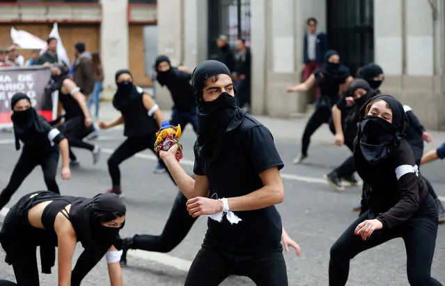 Masked demonstrators performs and take part in a protest against government education reforms in Valparaiso city, Chile, June 9, 2016. (Photo by Rodrigo Garrido/Reuters)