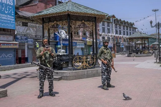 Paramilitary soldiers keep vigil with the help of a drone during shutdown in central Srinagar, Indian controlled Kashmir, Wednesday, May 25, 2022. (Photo by Dar Yasin/AP Photo)