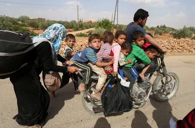Civilians, who fled the violence in Manbij city, arrive to the southeastern rural area of Manbij, in Aleppo Governorate, Syria June 19, 2016. (Photo by Rodi Said/Reuters)